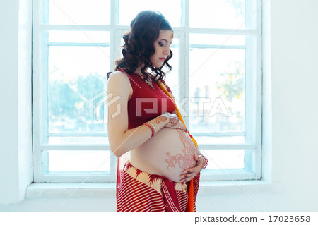 The pregnant woman belly with henna tattoo 17023658