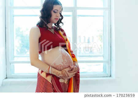 The pregnant woman belly with henna tattoo 17023659