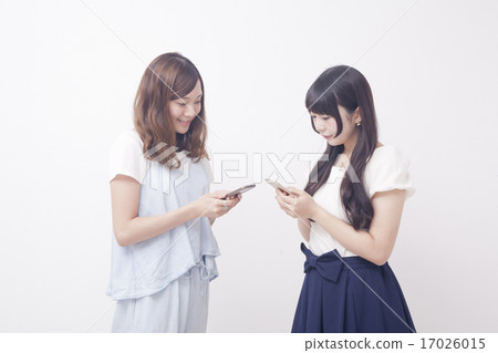 Two women with mobile phones Two women with mobile phones 17026015
