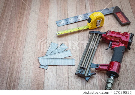 Close up air nail gun with measurement tools 17029835