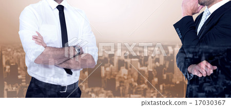 Composite image of smiling businessman with arms crossed 17030367