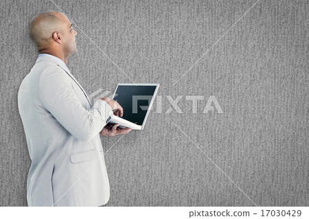 Composite image of businessman using laptop Composite image of businessman using laptop 17030429