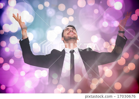 Composite image of businessman cheering with hands raised 17030676