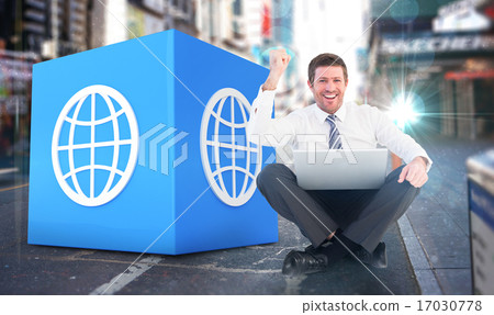 Composite image of businessman using laptop and cheering 17030778