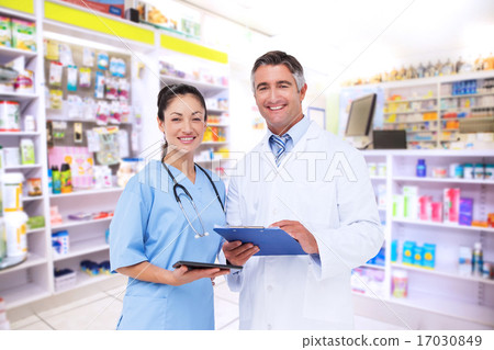 Composite image of doctor and nurse smiling at camera Composite image of doctor and nurse smiling at camera 17030849