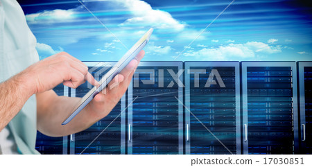Composite image of man using tablet pc Composite image of man using tablet pc 17030851