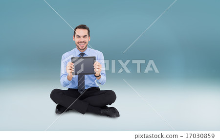 Composite image of smiling businessman showing his digital table Composite image of smiling businessman showing his digital table 17030859