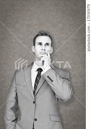 Composite image of businessman thinking 17030979