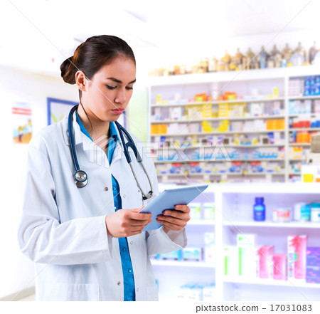 Composite image of young doctor standing with tablet pc Composite image of young doctor standing with tablet pc 17031083