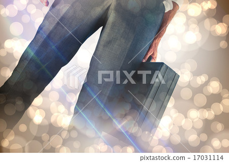 Composite image of businessman holding briefcase 17031114