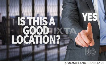 Composite image of businessman in grey suit pointing 17031238