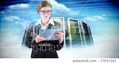 Composite image of redhead businesswoman using her tablet pc Composite image of redhead businesswoman using her tablet pc 17031392