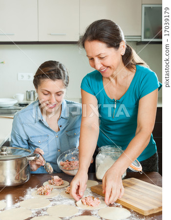 women making pies or meat dumplings 17039179