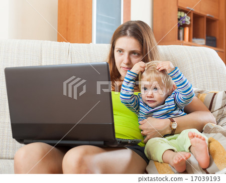 sorehead mother with baby working online 17039193
