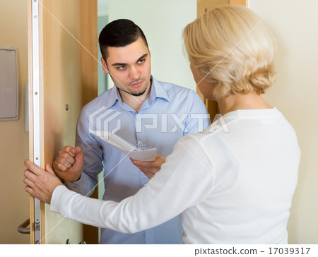 Serious man and housewife at the door 17039317