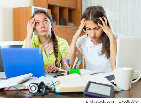 Sad students studying at home. 17039370