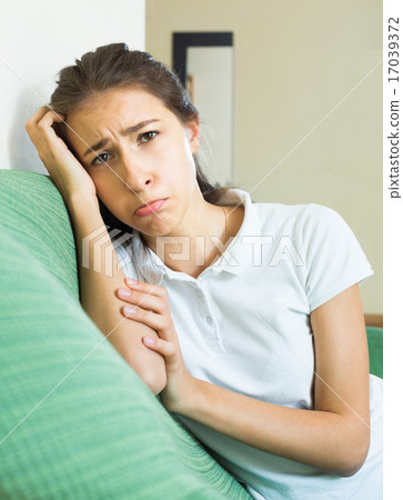 Alone sad girl suffering from troubles in home Alone sad girl suffering from troubles in home 17039372