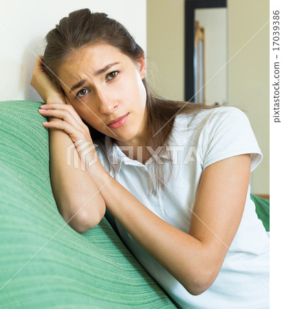 Portrait of upset young girl in home Portrait of upset young girl in home 17039386