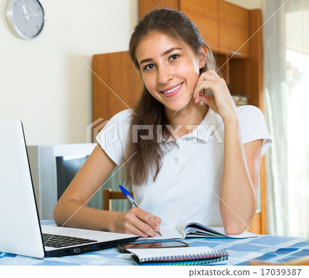 Teenager girl doing homework . 17039387