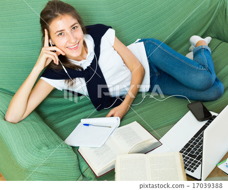 young girl using laptop at home 17039388