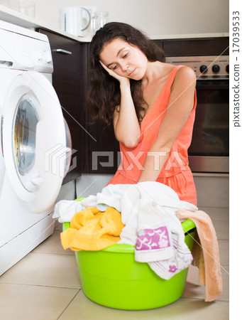 Tired woman near washing machine Tired woman near washing machine 17039533