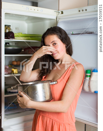 Girl holding her nose because of bad smell Girl holding her nose because of bad smell 17039551