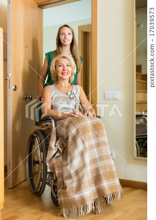 Girl helping handicapped woman Girl helping handicapped woman 17039573