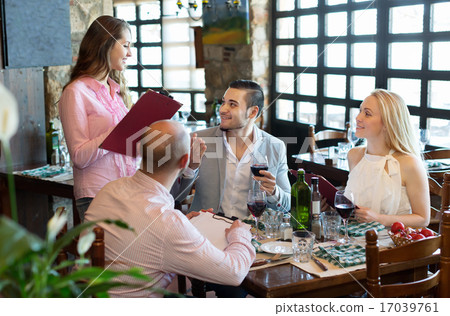 Adults having dinner and waiter 17039761