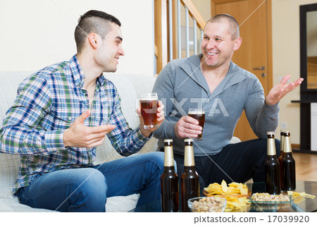 Two man with beer sit and talk Two man with beer sit and talk 17039920