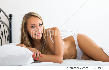 Blonde woman waking on bed 17039983