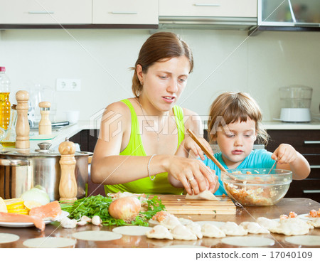 mother with her daughter doing Fish dumplings in a huge house i 17040109