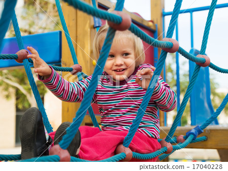 Happy little girl at action-oriented playground 17040228