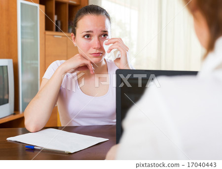 Sad woman filling questionnaire 17040443