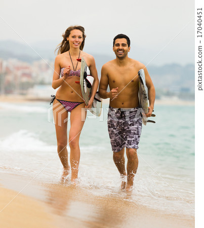Young surfers couple on the beach Young surfers couple on the beach 17040451