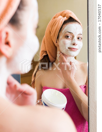 Girl applying cream on skin 17040537