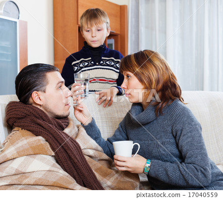 Unwell man surrounded by caring wife and son Unwell man surrounded by caring wife and son 17040559
