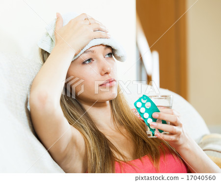 Sick girl with glass of water taking medicine Sick girl with glass of water taking medicine 17040560