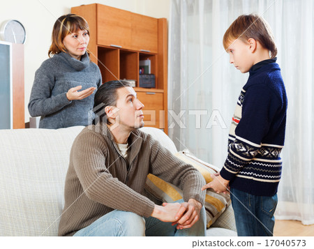 Mother and father together scolding teenager son Mother and father together scolding teenager son 17040573