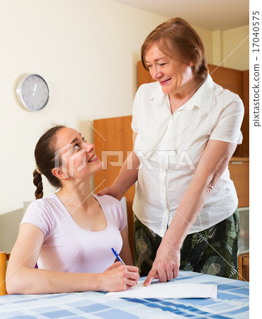 Happy women with financial documents at table 17040575