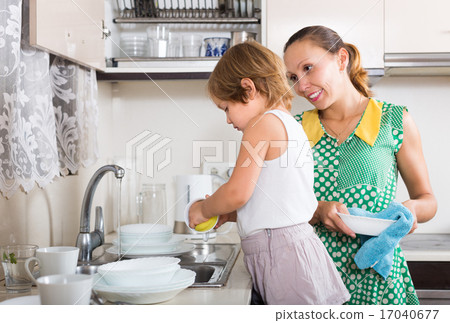 Girl helping mother washing dishes 17040677