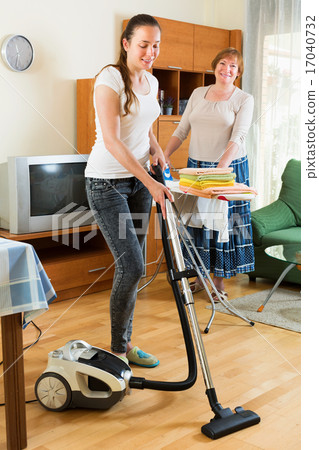 Young girl with vacuum cleaner do housework Young girl with vacuum cleaner do housework 17040732