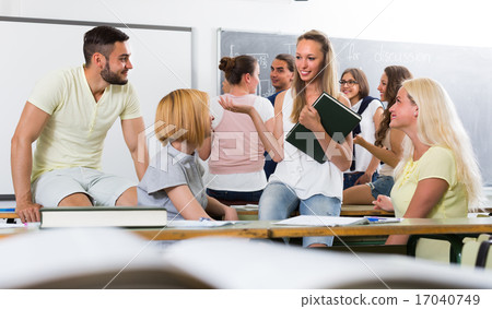 students chatting while sitting in the room 17040749