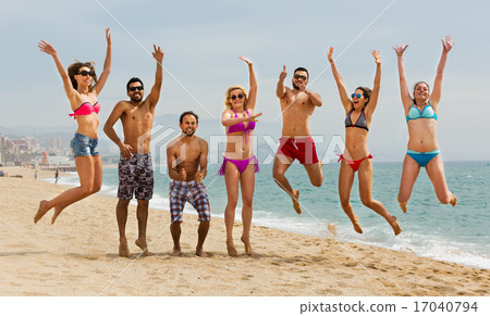 People jumping at beach People jumping at beach 17040794