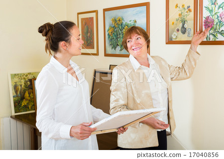 Women looking at the artwork Women looking at the artwork 17040856