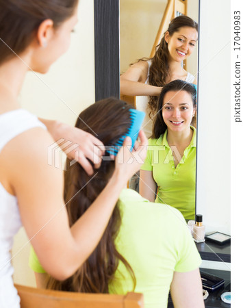 Young girl combing the hair 17040983
