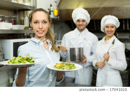 Waitress with plates at kitchen 17041028