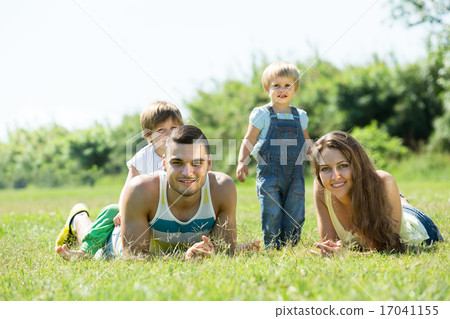 Family of four in sunny park Family of four in sunny park 17041155