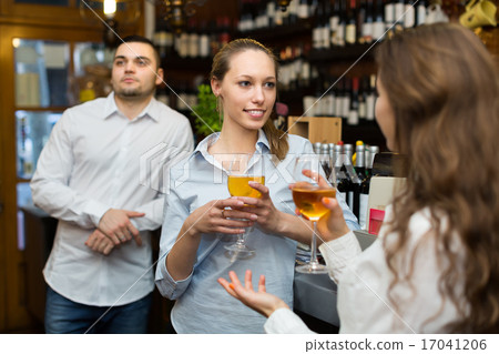Two girls with man at bar Two girls with man at bar 17041206