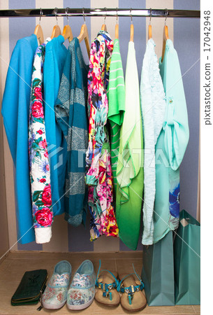 Colored female clothes on hangers in wardrobe Colored female clothes on hangers in wardrobe 17042948