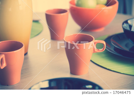 Close up of orange cup on wooden table 17046475